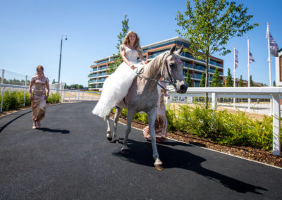 Bride arriving on horse at Newbury Racecourse
